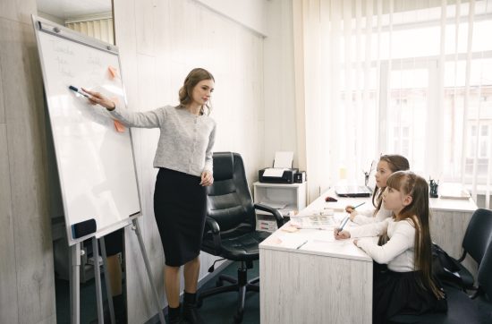 Teacher supporting students in a classroom