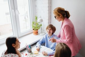Parent and educators meeting with a student at a table