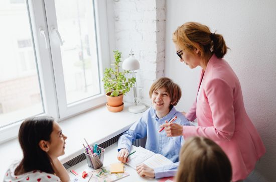 Parent and educators meeting with a student at a table